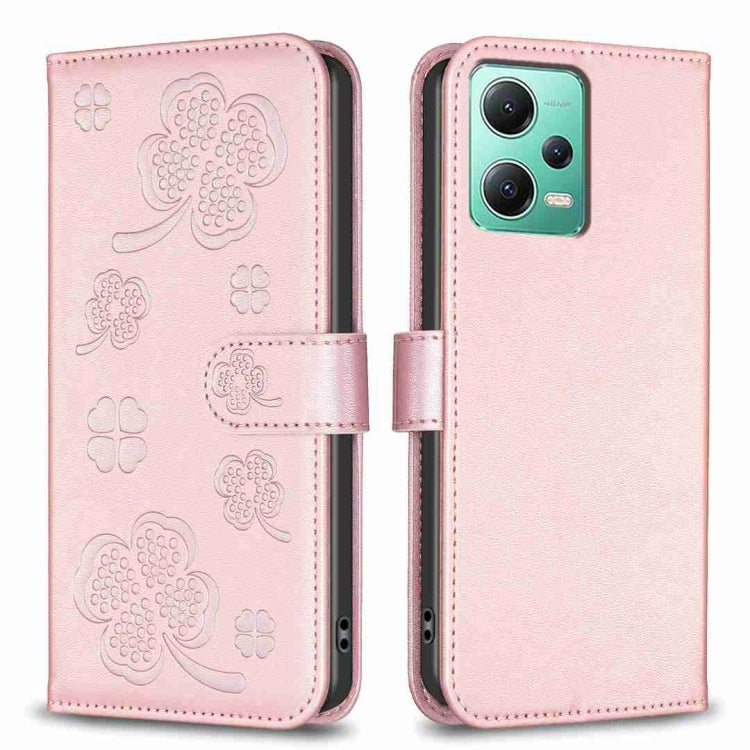 Pink embossed leather-style phone case with four-leaf clover pattern and folio flap