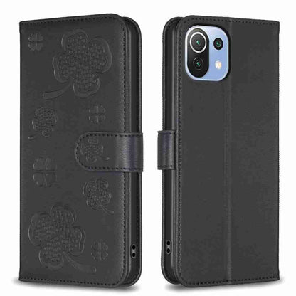 Black embossed four-leaf clover leather wallet phone case with magnetic flap.