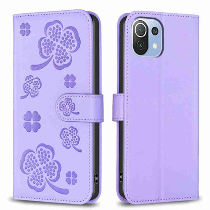 Lavender embossed four-leaf clover leather wallet phone case with magnetic flap.