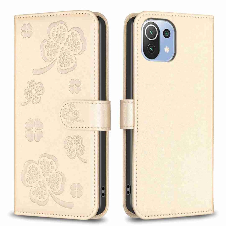 Beige embossed four-leaf clover leather wallet phone case with magnetic flap.