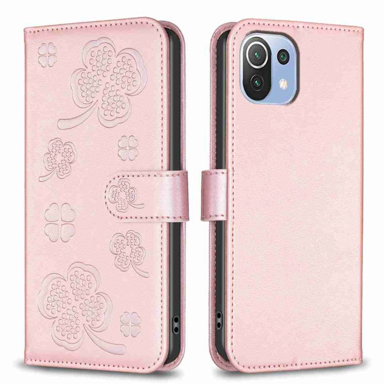 Light pink embossed four-leaf clover leather wallet phone case with magnetic flap.