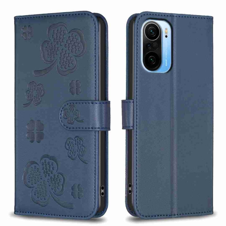 Four-leaf embossed leather phone case with folio flap, dark blue with clover pattern.