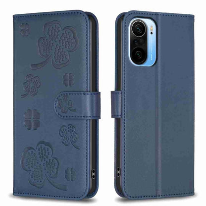 Four-leaf embossed leather phone case with folio flap, dark blue with clover pattern.