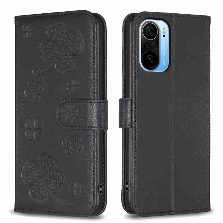 Black embossed leather phone case with four-leaf clover pattern and flip strap