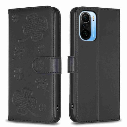 Black embossed leather phone case with four-leaf clover pattern and flip strap