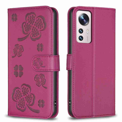 Four-leaf embossed leather phone case with folio strap, deep magenta