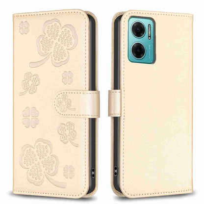 Embossed leather phone case with clover pattern and side flip strap, beige/gold