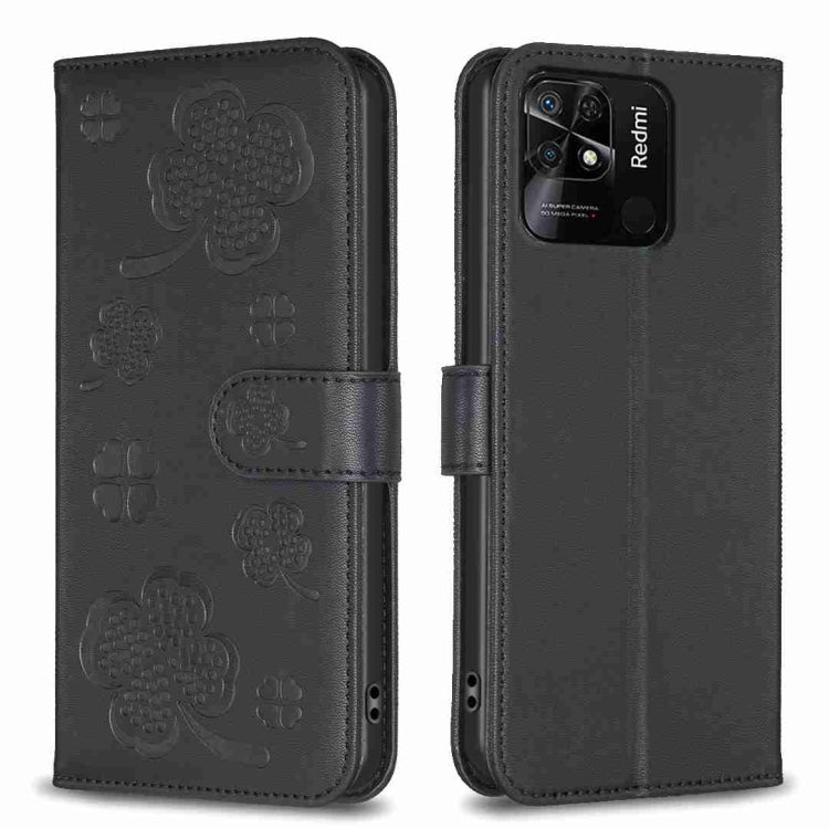 Four-leaf embossed leather phone case with folio flap, black with clover pattern.