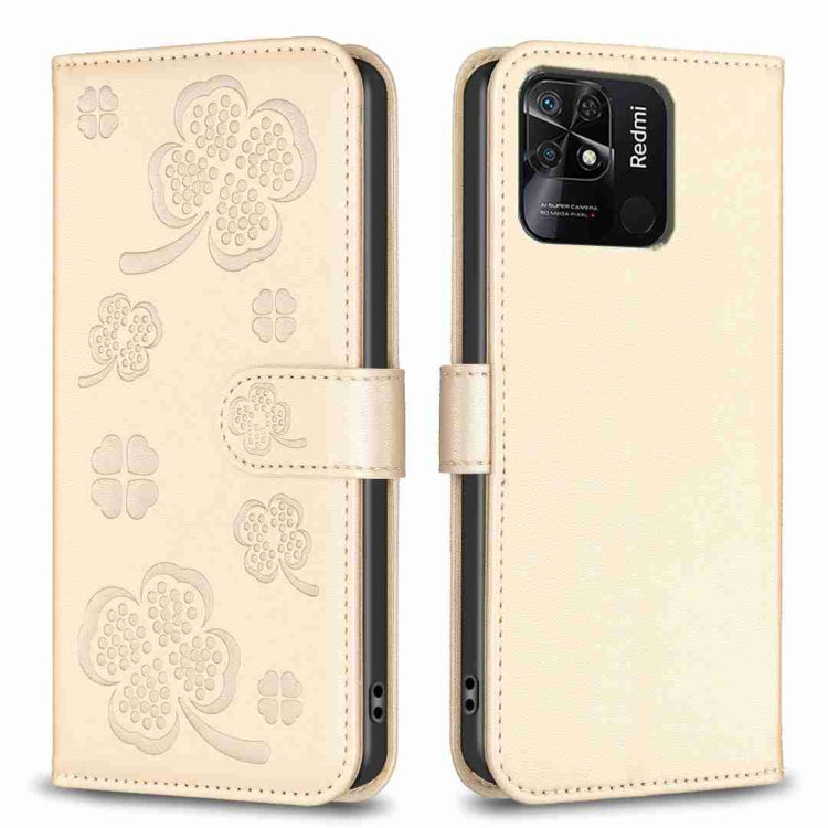 Four-leaf embossed leather phone case with folio flap, beige with clover pattern, close-up.