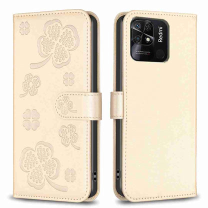 Four-leaf embossed leather phone case with folio flap, beige with clover pattern, close-up.
