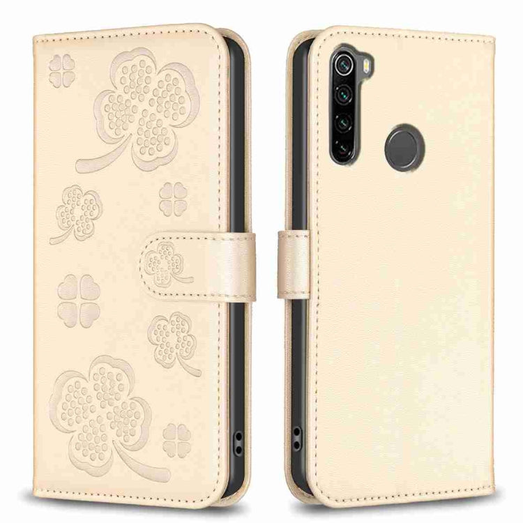 Beige embossed four-leaf clover leather phone case with fold-over strap and camera cutout