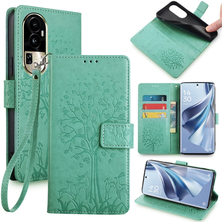 Green embossed leather phone case with tree-and-deer pattern, folio wallet and wrist strap