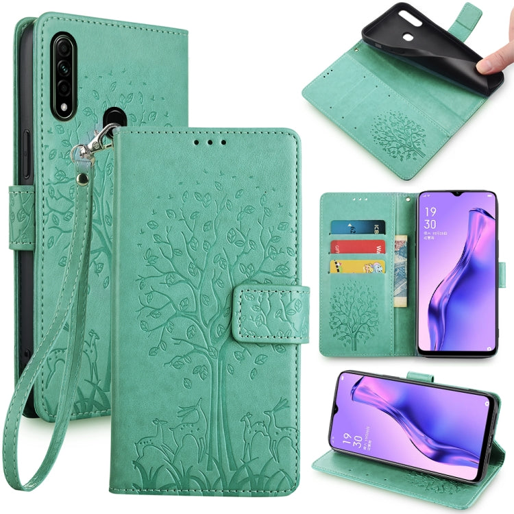 Green embossed leather phone wallet case with tree and deer pattern, wrist strap, cutouts