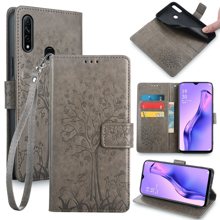 Grey embossed leather phone wallet case with tree and deer pattern, wrist strap, cutouts