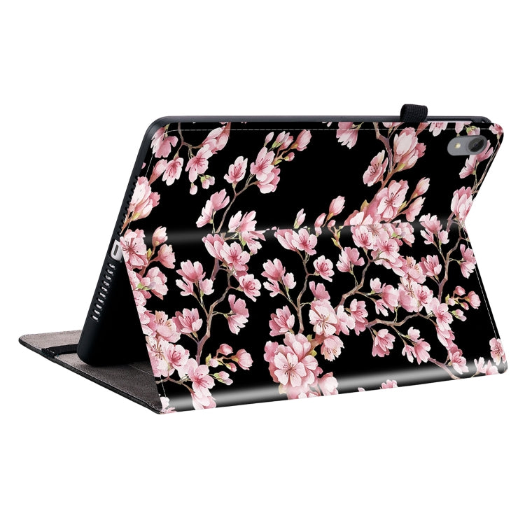 Black folio tablet case with pink cherry blossom print and angled stand