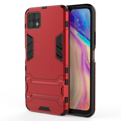 Red rugged shockproof phone case with holder, raised protective corners and camera cutouts
