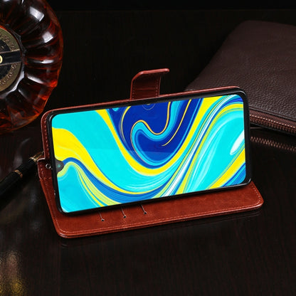 Red-brown leather flip phone wallet case holding a phone with front screen visible