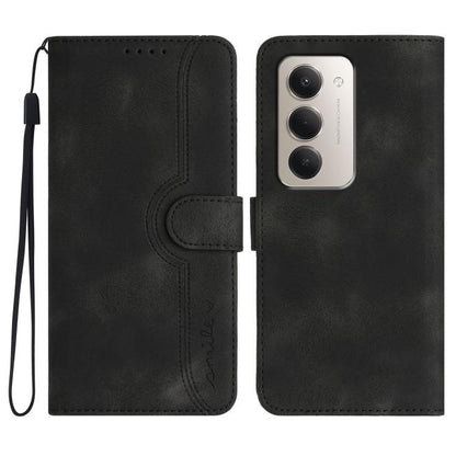 Black heart-pattern faux leather flip phone case with wrist strap and camera cutout.