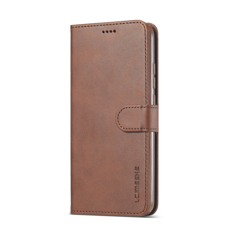 Brown leather flip phone case with strap closure and front card slot panel