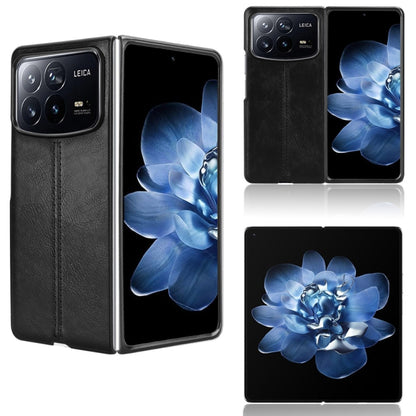 Folding phone case with black faux leather finish and blue flower design on front