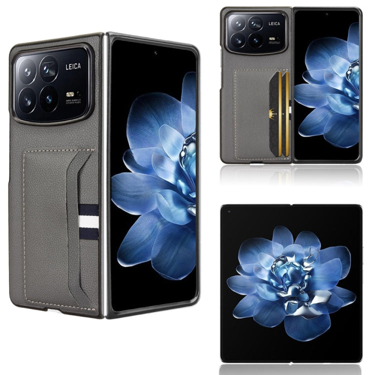 Gray phone case with litchi texture and card slot; flip cover with striped band.