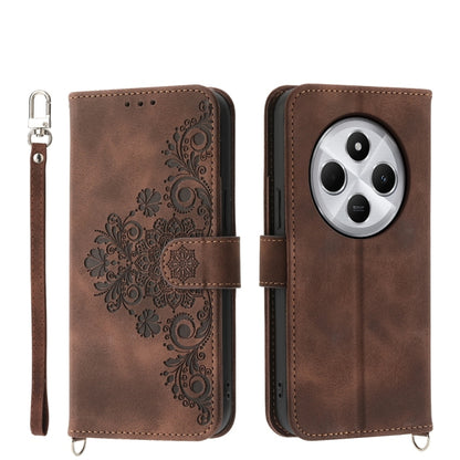 Brown floral embossed wallet phone case with wrist strap and camera cutout