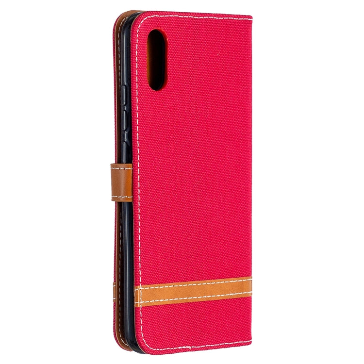 Red flip phone wallet case with tan border and denim-texture finish, side view