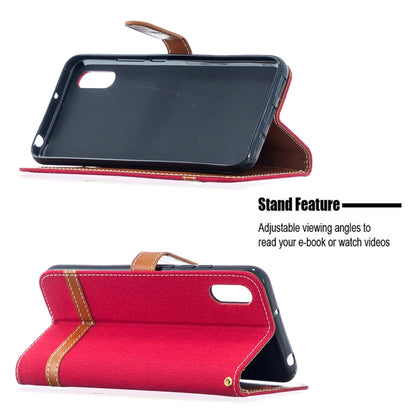 Red flip phone wallet case with tan accents, open stand position