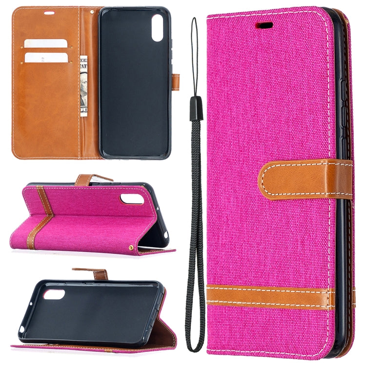 Hot pink denim-textured flip case with card slots and lanyard, tan leather trim.