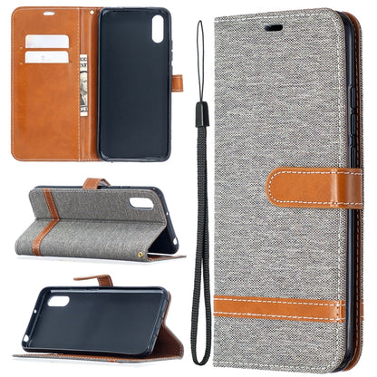 Grey denim-textured flip case with card slots, brown leather trim, and lanyard.