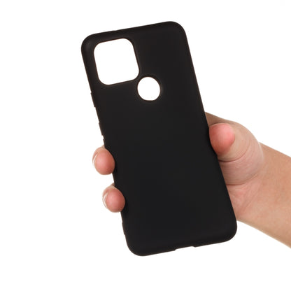 Black full-coverage liquid silicone phone case held in hand, with camera and speaker cutouts
