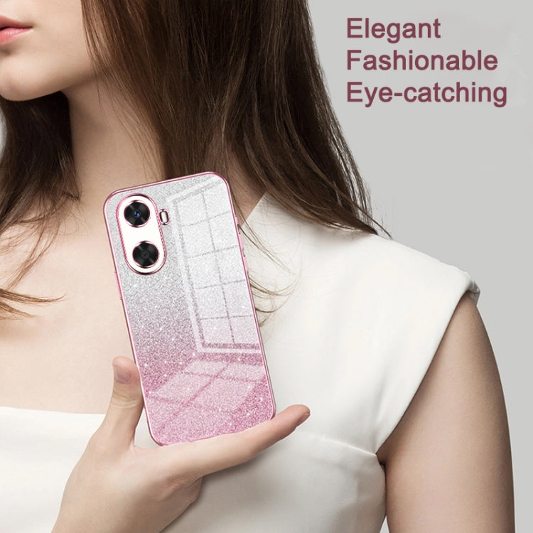 Pink glitter phone case with transparent back held in hand, dual camera cutouts