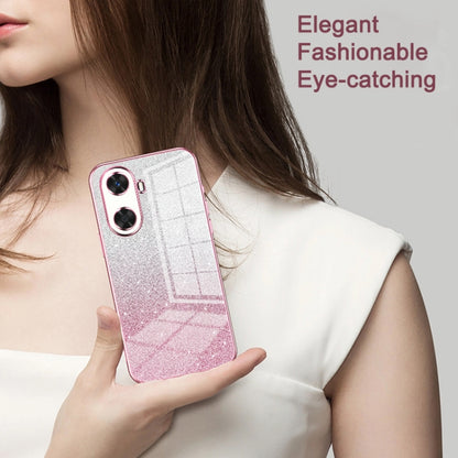 Pink glitter phone case with transparent back held in hand, dual camera cutouts