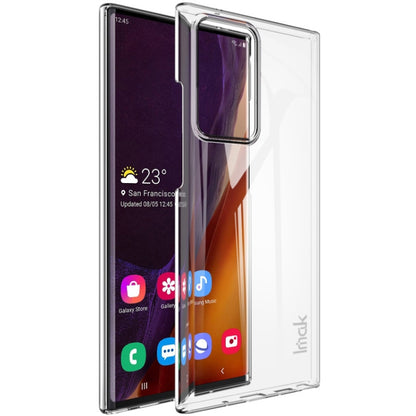 Clear hard phone case with raised edges and camera cutout over smartphone