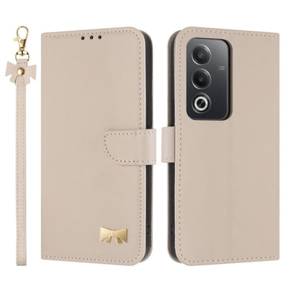 Beige leather phone case with wrist strap and bow charm, folio flap and camera cutout