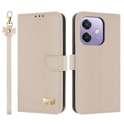 Beige leather phone case with hand strap, folio flap, metal bow charm, card holder.