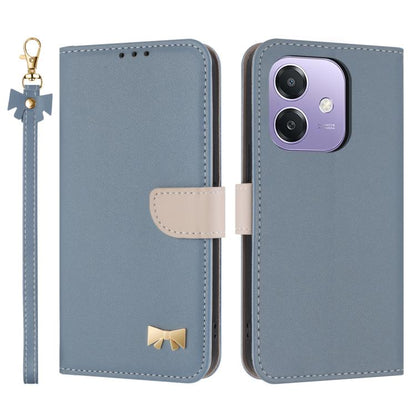 Light blue leather phone case with hand strap, folio flap, metal bow charm, card holder.