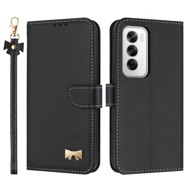 Black leather phone case with hand strap and bow charm, showing camera cutout