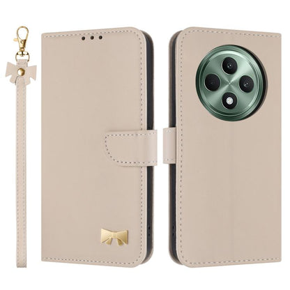 Beige leather phone case with hand strap, folio flap, metal bow charm, camera cutout.