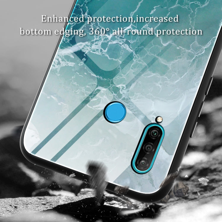 Marble-pattern glass phone case with teal marbled texture; blue power and dual camera cutouts