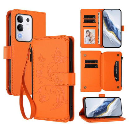 Orange leather wallet phone case with floral butterfly pattern, zipper and wrist strap.