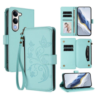 Mint green leather zip-around phone wallet with butterfly flower embossing, card slots, wrist strap.