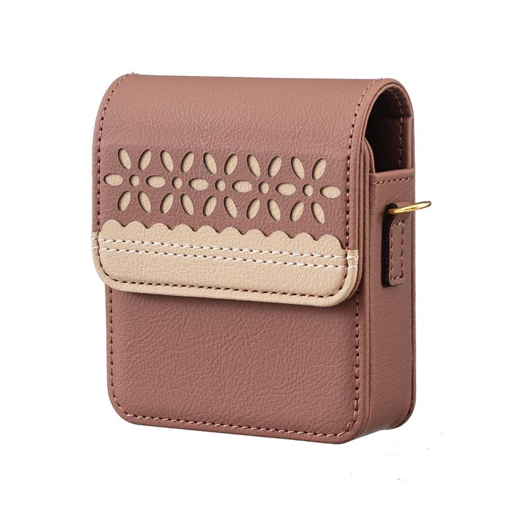 Brown leather flip phone bag with cutout floral design, top flap, and stitched cream trim