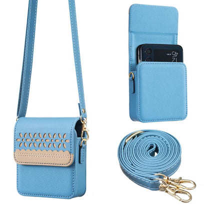 Light blue leather crossbody flip phone bag with cutout floral panel and matching strap