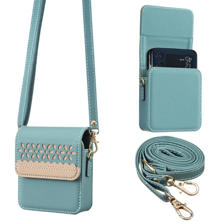 Light teal leather crossbody flip phone bag with cutout floral front and detachable strap