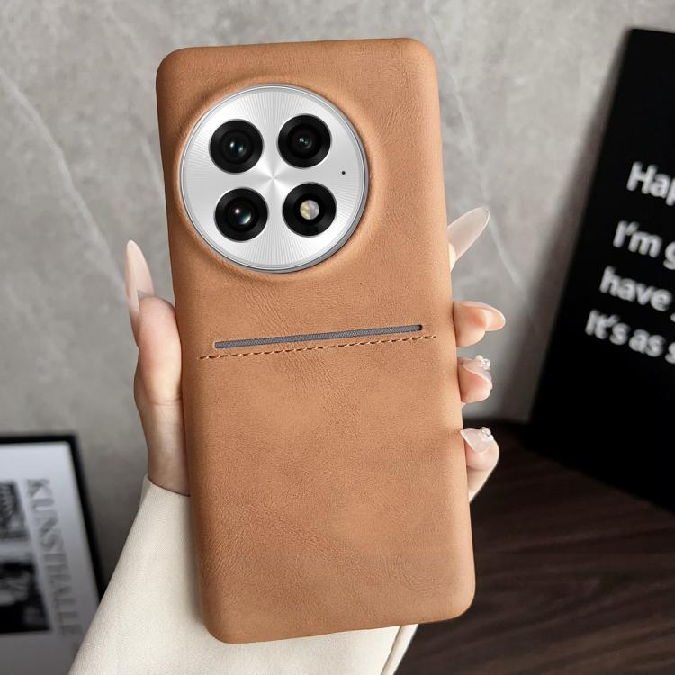 Tan sheepskin card slot phone case with circular camera cutouts and stitched band