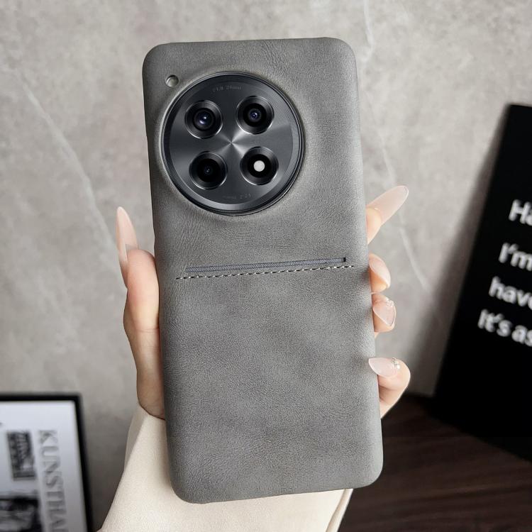 Grey sheepskin card slot phone case with camera cutout and stitched strap detail