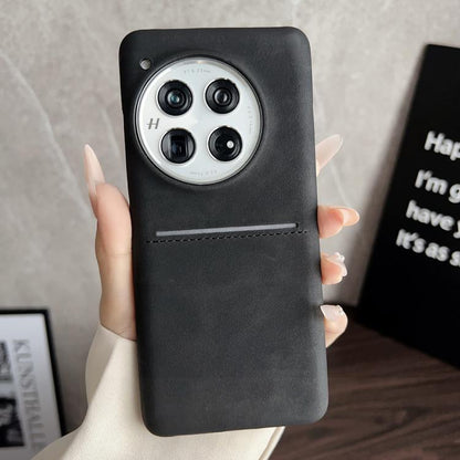Black sheepskin card slot phone case with camera cutout and stitched strap detail