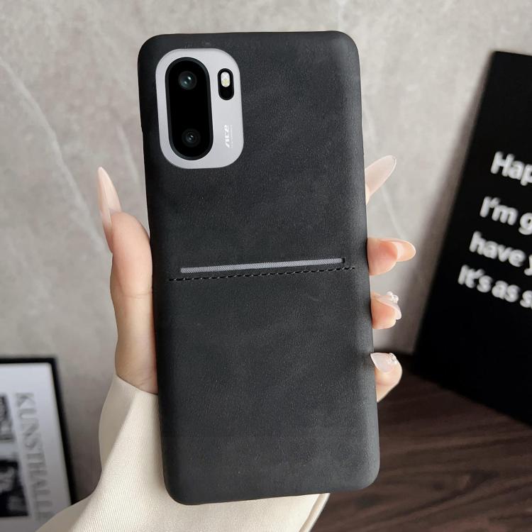 Black sheepskin-feel phone case with card slot, stitched trim, and camera cutout
