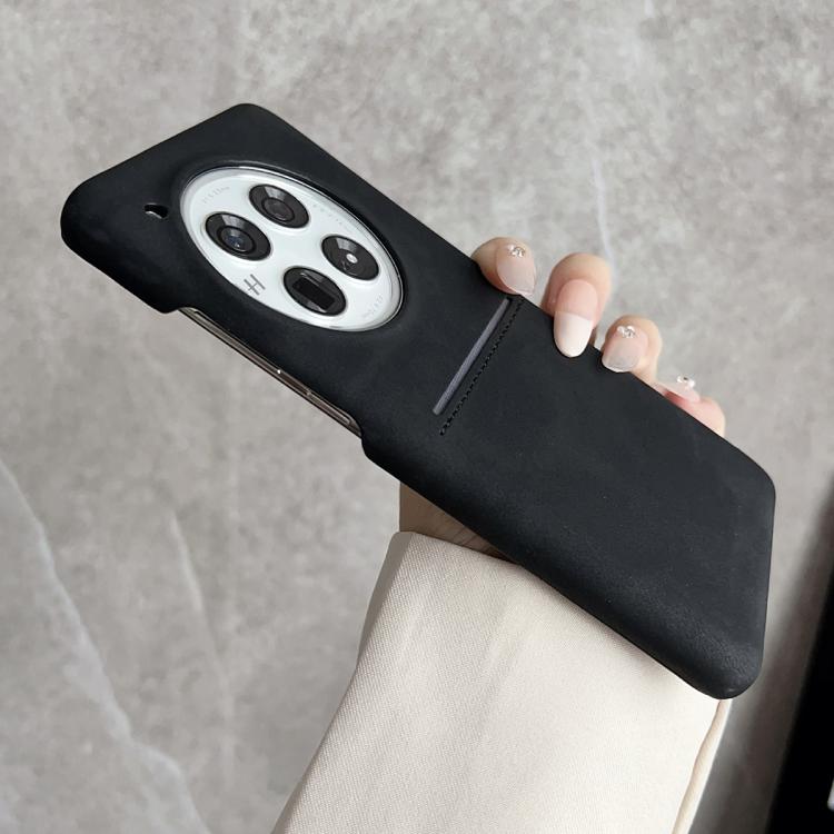Black sheepskin phone case with card slot and camera cutout, stitched edges
